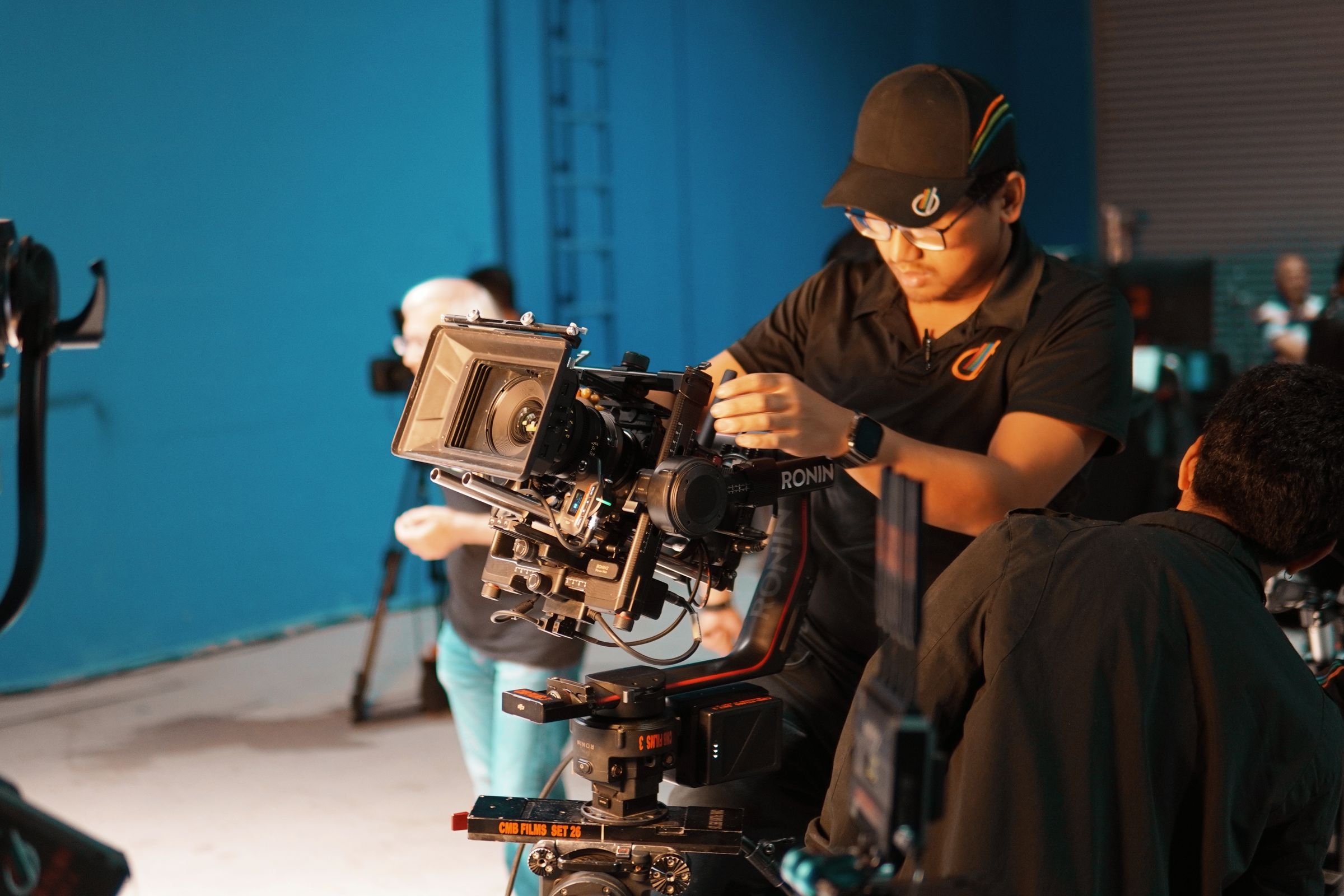 A crew setting up professional camera equipment in a studio.