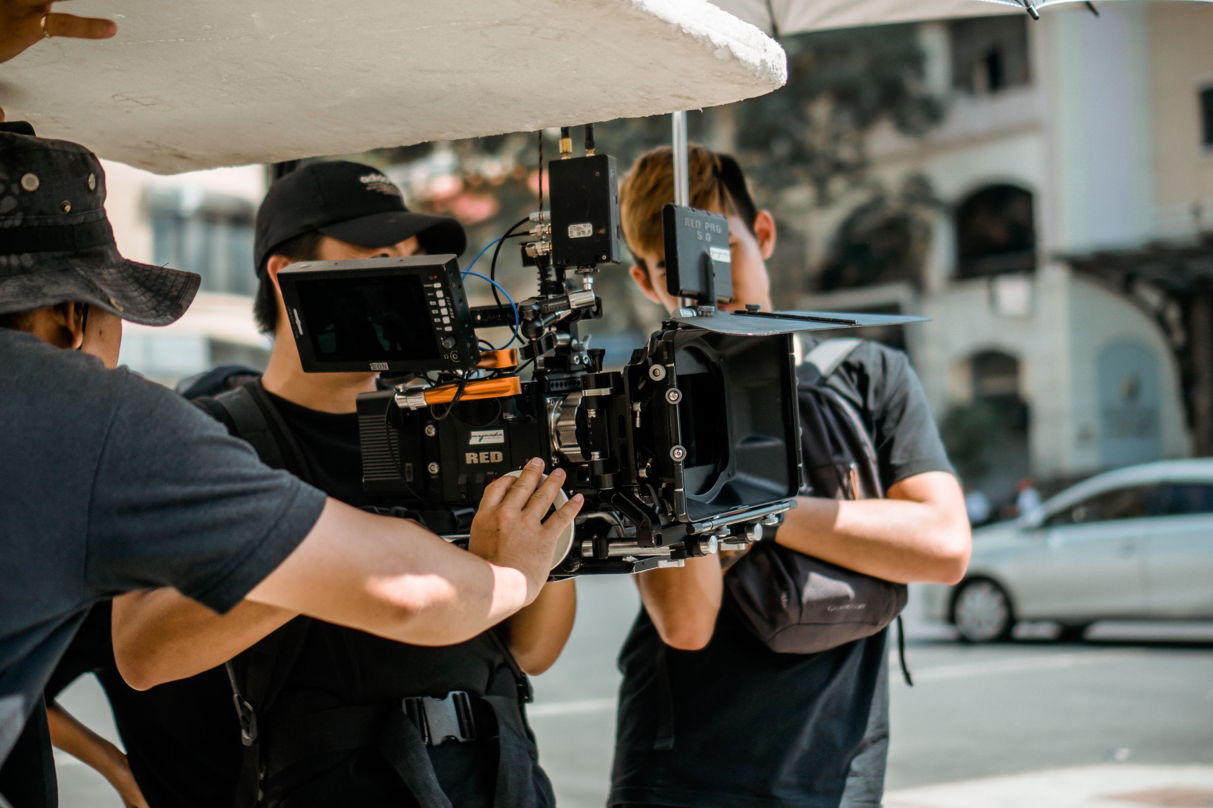 A film crew operating a cinema camera on a city street.