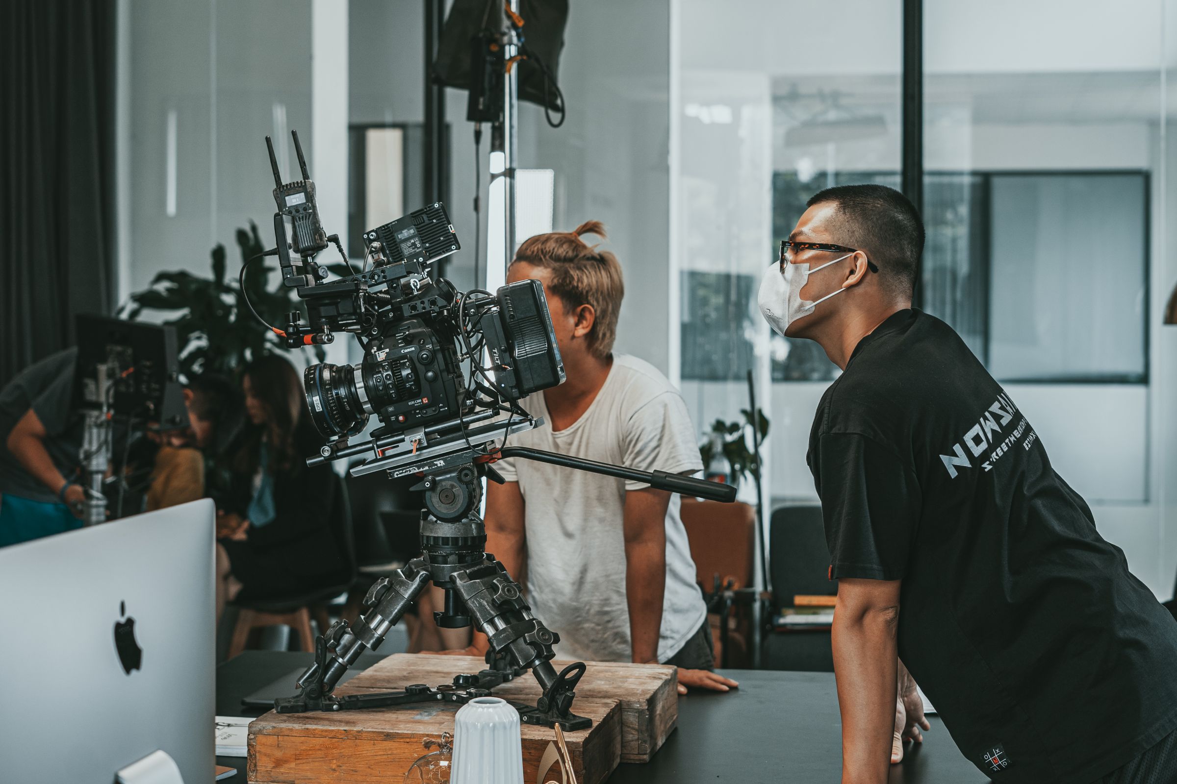 A film crew collaborating in a modern studio.